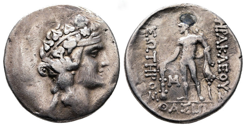 Ancient greek silver tetradrachm coin with a portrait of young dionysus on one side herakles on other