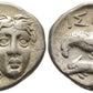 Front and Backside of ancient silver greek  istrus coin with inverted  faces on one side, and sea-eagle clutching dolphin with  inscriptions on other side